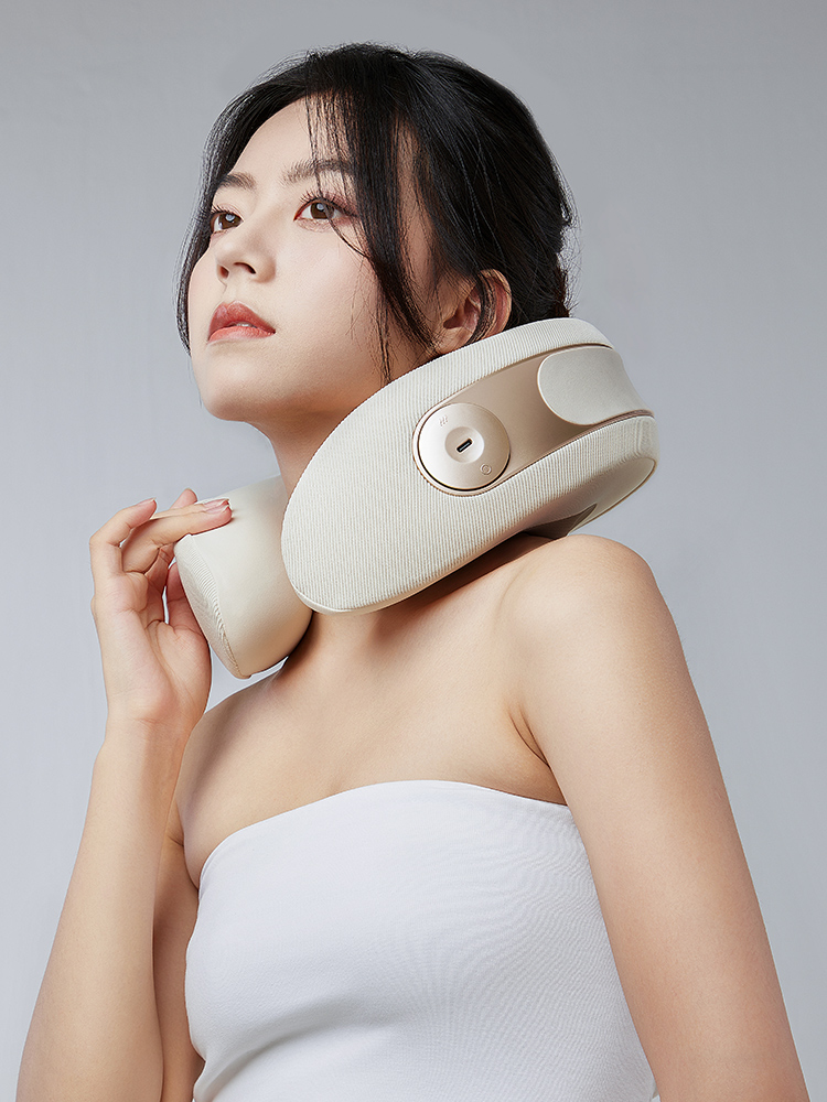 A woman wearing the cream MT02 neck massager