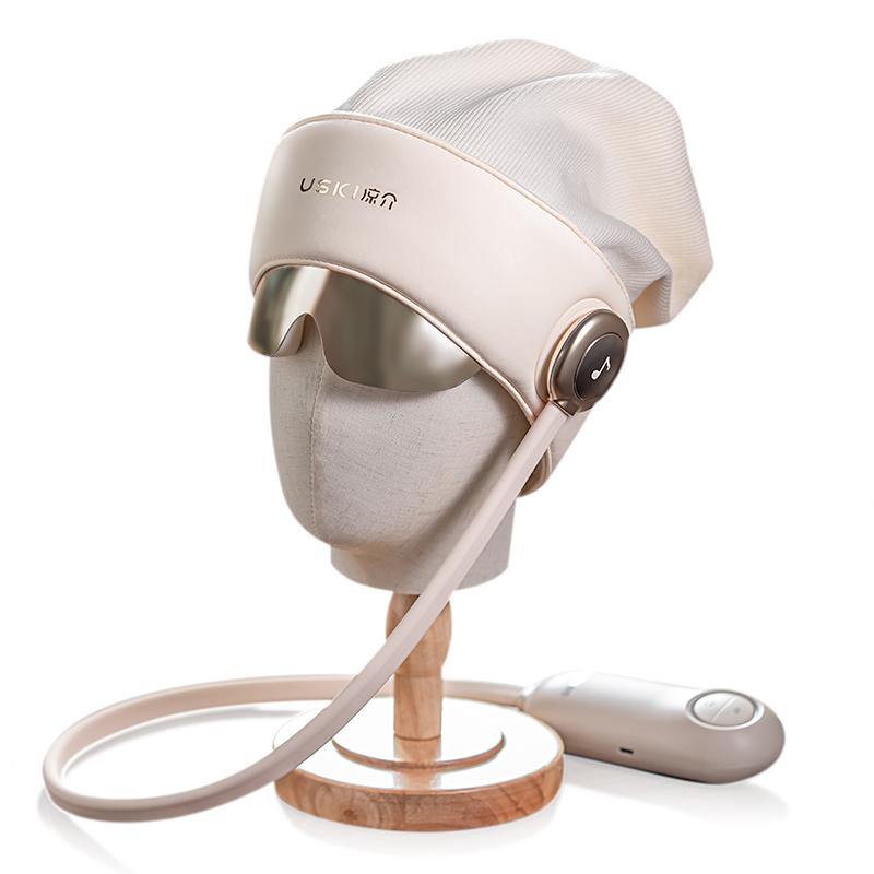 R2 head massager in cream with a silver visor and handheld control